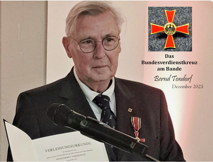 Bernd Tondorf erhält für sein Engagement das Bundesverdienstkreuz. Er hält auf dem Foto die Urkunde in der Hand. In Brusthöhe hängt das Verdienstkreuz an seinem schwarzen Anzug.